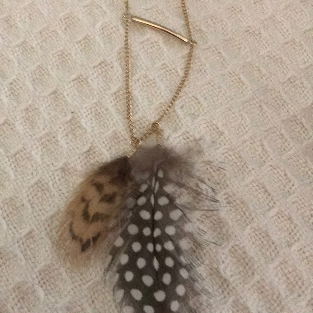 Feather and gold necklaces